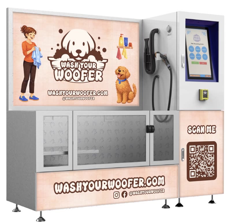 The self-service wash station unit with its shower hose, payment screen and drying cabinet, wording cropped out